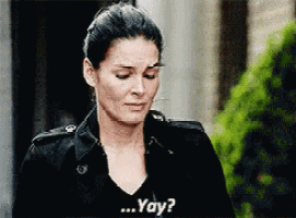 a woman in a black jacket is asking the question " yay "