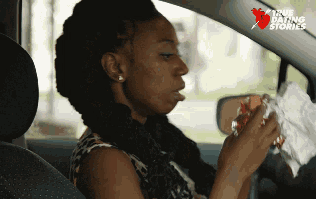 a woman eating a hot dog in a car with a true dating story logo
