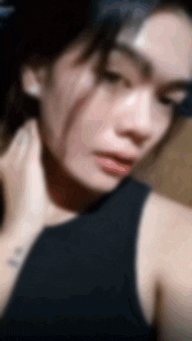 a blurry picture of a woman in a black tank top