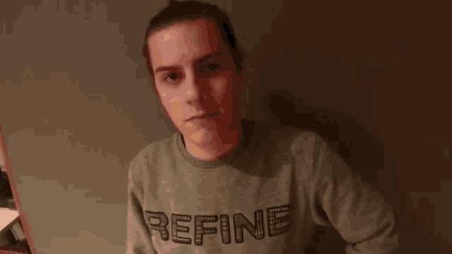 a man wearing a grey sweater that says fine
