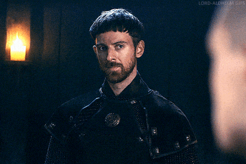 a man with a beard is looking at another man with the words lord-aldhelm.gifs below him
