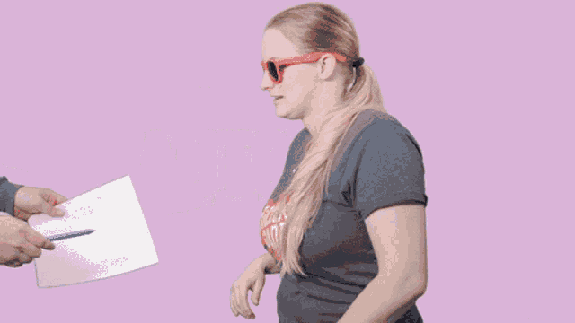 a woman wearing sunglasses and a t-shirt that says sticks and giant
