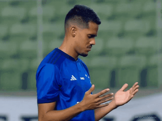a soccer player wearing a blue adidas jersey