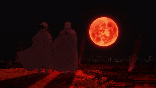 a couple of people standing in front of a red moon