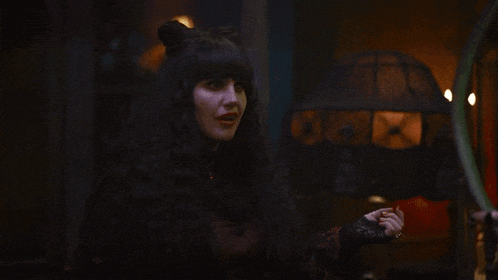 a woman in a black cat costume with ears on her head