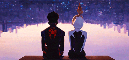 a man and a woman are sitting on a ledge looking at the city skyline .