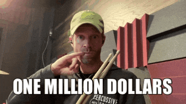 a man is holding a pair of drumsticks and says " one million dollars "