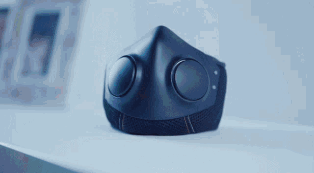a blue face mask with two buttons on the side
