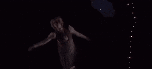a woman in a striped dress is flying through the air