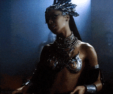 a woman with a crown on her head is wearing a bra