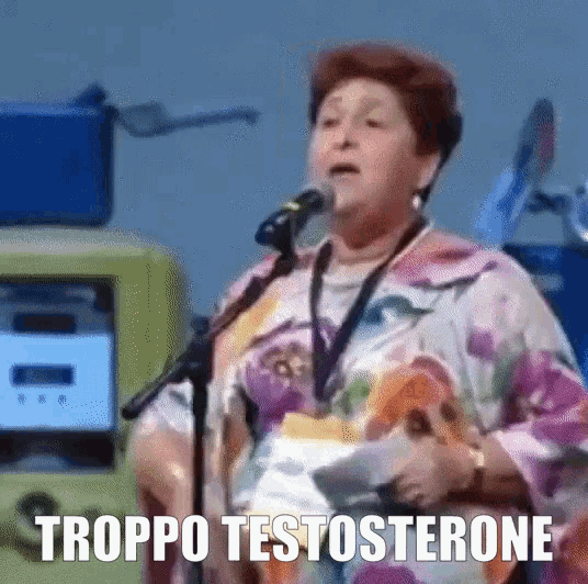 a woman is speaking into a microphone and the words troppo testosterone are visible