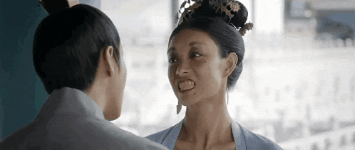 a man and a woman are standing next to each other and looking at each other .