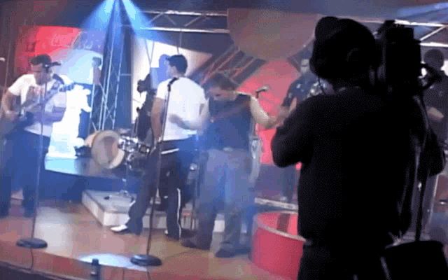 a group of people playing instruments in front of a sign that says coca-cola