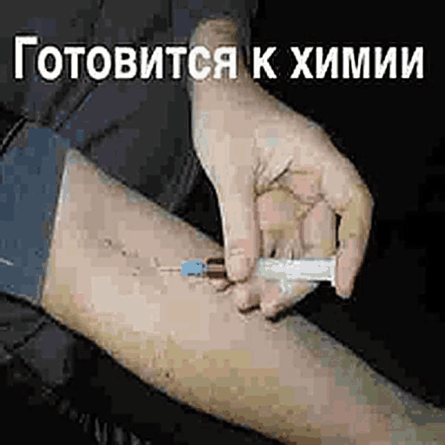 a person is holding a syringe in their hand and injecting something into another person 's arm .