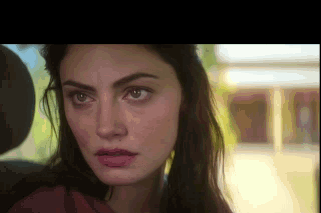 a close up of a woman 's face in a car