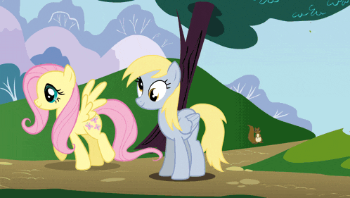 a couple of ponies are standing next to each other on a path
