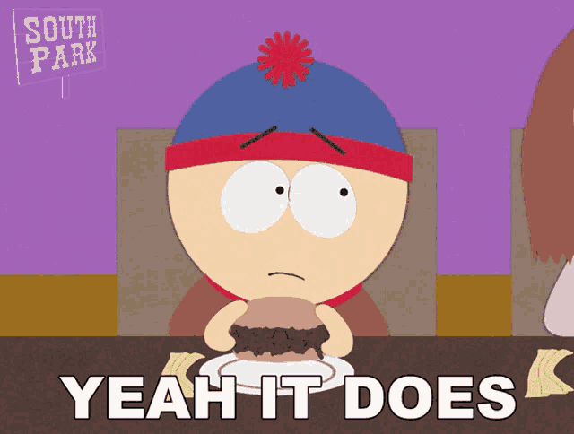 stan marsh from south park sits at a table eating a hamburger and says yeah it does