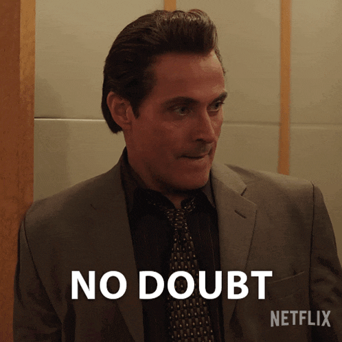 a man in a suit and tie says " no doubt " in white letters