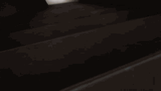 a staircase with a light coming out of the door