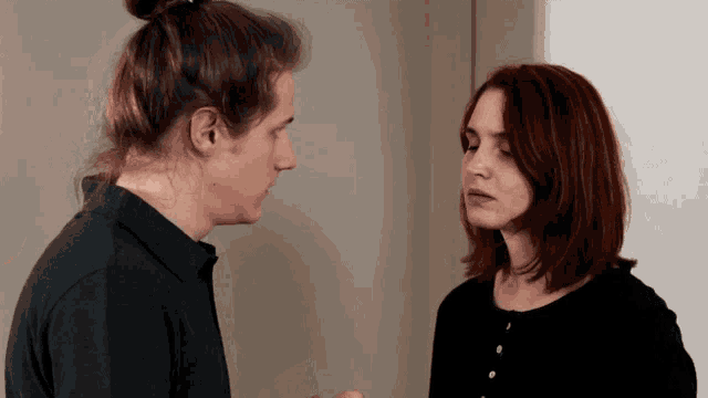 a man and a woman looking at each other