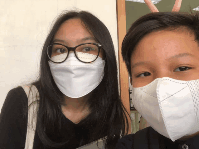 a boy and a girl wearing face masks with kn95 on them