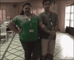 a man and a woman standing next to each other in a room