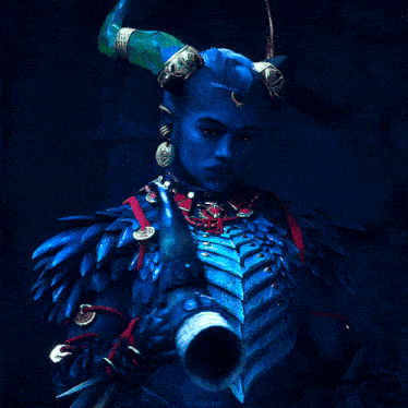 a blue demon with horns and a skull bracelet