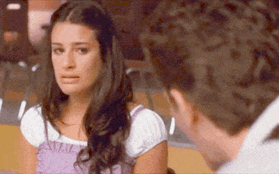 a woman in a purple dress is crying next to a man