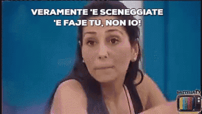 a woman is sitting in front of a television with the words veramente ' e sceneggiate
