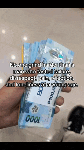 a hand holding a stack of 1000 bills