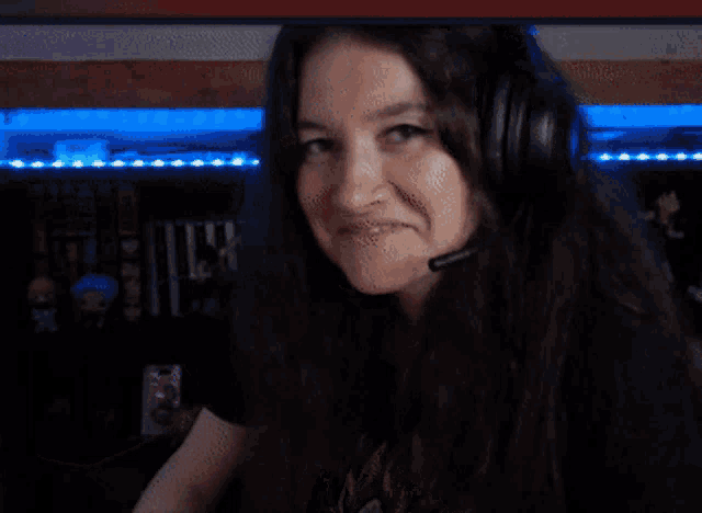 a woman wearing headphones and a microphone looks at something