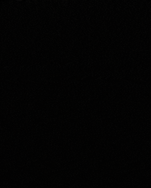 a man in a suit and white shirt stands in front of a black background with foreign writing