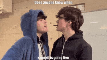 a couple of boys standing next to each other with the caption " does anyone know when supertf is going live "