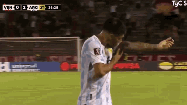 a soccer player is standing on a field with a score of 2 to 2