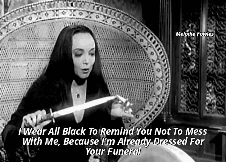 a black and white photo of a woman holding a knife and saying " i wear all black to remind you not to mess with me