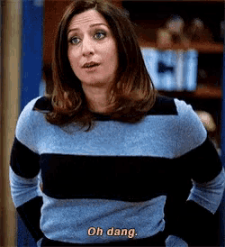 a woman in a blue and black striped shirt says oh dang