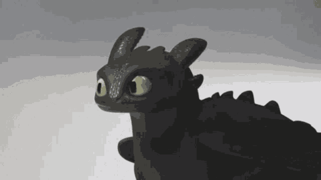 toothless from how to train your dragon looks at the camera with his eyes glowing