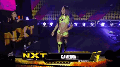 a female wrestler named cameron stands on a stage