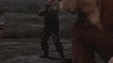 a woman in a plaid skirt kicks a man in a military uniform
