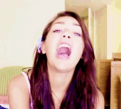 a woman is making a face with her mouth wide open