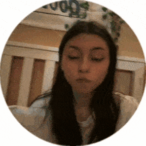a woman is sitting in a crib with her eyes closed and making a funny face .