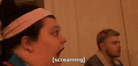 a blurry picture of a person screaming with the word screaming written in white