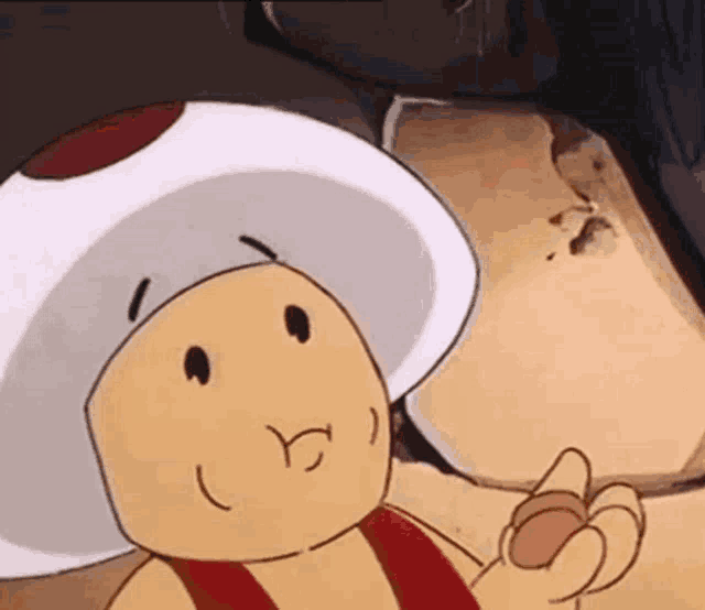 a close up of a cartoon toad with a red and white hat and a red belt .