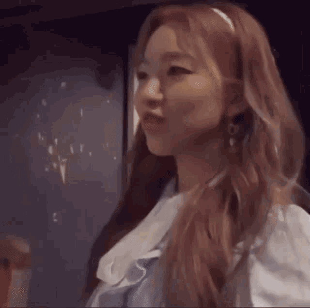 a close up of a woman 's face with korean writing on the bottom