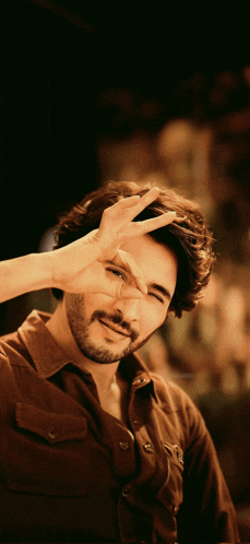 a man making a peace sign with his hands