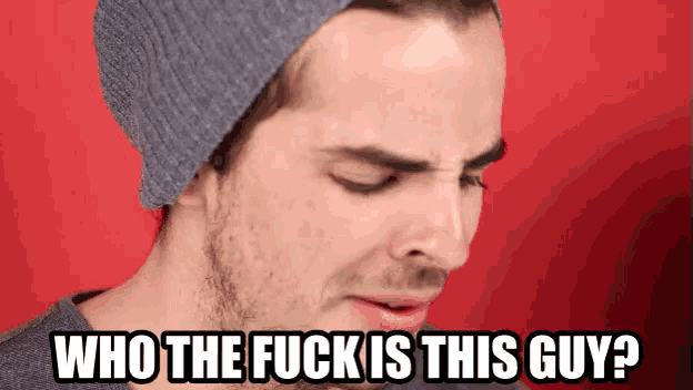 a man wearing a beanie and a sweater says who the fuck is this guy