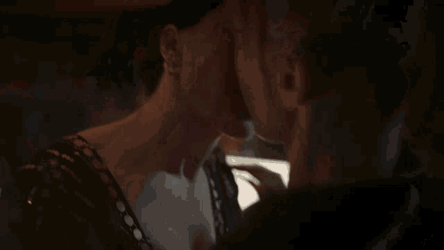 a man and woman are hugging in front of a painting