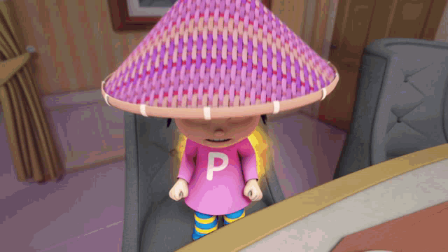 a girl in a pink shirt with the letter p on it is wearing a purple hat