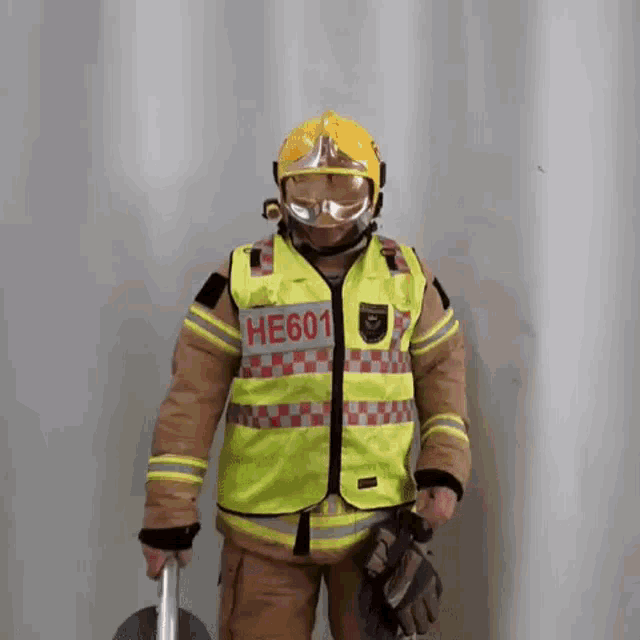 a fireman wearing a yellow vest with the number he601 on it