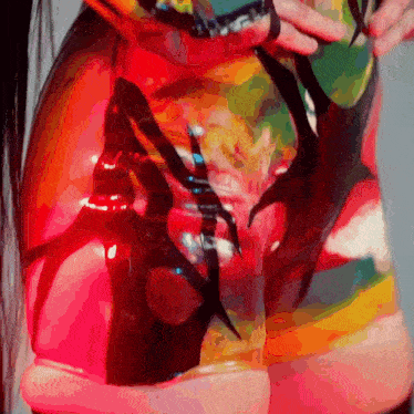 a close up of a woman 's torso with a colorful design